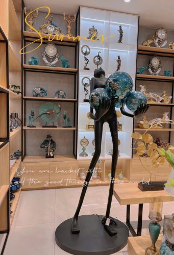 Black statue holding blue ball